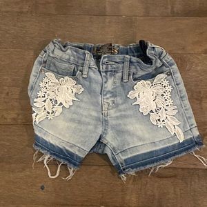 jean shorts with sewed on floral pattern